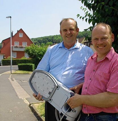 <p>Nicht nur die 60 neuen "Kofferleuchten" strahlen im älteren Baugebiet von Tauberrettersheim, sondern auch Bürgermeister Hermann Öchsner und Elektromeister Volker Müller (rechts) vom Elektrizitätswerk Müller.</p>