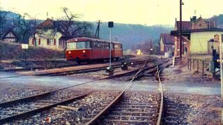 Bahnhof Reicholzheim mit Güterhalle, Bahnübergang und Gleisanlagen - Ausfahrt eines Schienenbusses am 10. Februar 1972 .