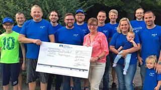 Mit großer Freude nahm Karin Rost (Mitte) von „Hüttle 99“-Vorstandsmitglied Tino Kraus (hinterdem Scheck) und weiteren Vereinsmitgliedern die stolze Spendensumme von insgesamt 2100 Euro entgegen.