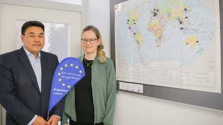 Prof. Dr. Seon-Su Kim, der Leiter des DHBW-Campus in Bad Mergentheim und Ressortleiter „Internationales“ der DHBW Mosbach, zusammen mit Anna-Magdalena Bröckl, Leiterin des International Office (IO) am Campus in Bad Mergentheim, vor der großen Weltkarte mit den eingezeichneten Partnerhochschulen weltweit.