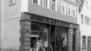 Das Leder- und Textilwarengeschäft Wolf in der Marktstraße 12 in Buchen. Seit 1921 führte das Ehepaar Susi und Herbert Levi den Betrieb. Dieses emigrierte 1938/39 unter dramatischen Umständen nach Südrhodesien. Das Haus musste es für 8000 Reichsmark abgeben.
