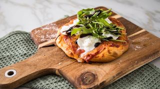 Die Verbindung von Mozzarella und Rucola auf der Pizza sorgt für einen wahren Geschmacksgenuss.