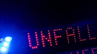 Das Blaulicht auf einem Fahrzeug der Polizei leuchtet in der Dunkelheit.
