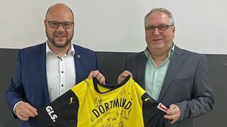 Bürgermeister Meikel Dörr (links) überreichte dem früheren Kämmerer Joachim Dörr ein Trikot seiner Lieblingsmannschaft zum Eintritt in den Ruhestand.