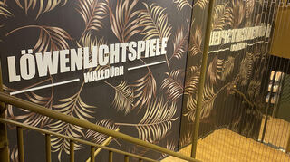 Schwarz, Gold und das Palmenmuster ziehen sich durch das Kino.