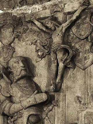 In der Gruft unter der Schlosskirche sieht man das steinerne Grabmonument des Wolfgang Schutzbar, der vor einem Kreuz kniet.